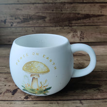 Load image into Gallery viewer, Holiday Mug with mushroom motif and writing Peace on Earth