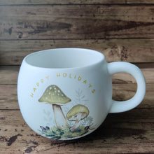 Load image into Gallery viewer, Holiday Mug with mushroom motif and writing Happy Holidays